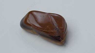 Natural mineral stone tiger eye gemstone. On a white background.