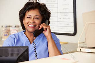 Nurse Making Phone Call At Nurses Station