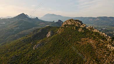 aerial scenic landscape with green fields, meadows, curved mountain river and mountain ridge with high mountains and