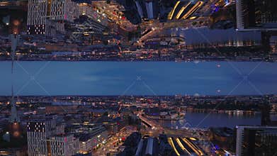 Forwards fly above evening city. Illuminated streets and buildings in metropolis, Stockholm, Sweden. Abstract computer