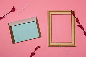 pink background with wooden frame on the right as copy space and vintage letter as copy space on the left