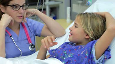 Young Girl Talking To Female Nurse In Intensive Care Unit