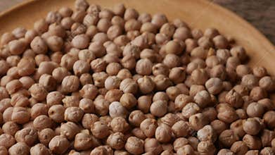 Raw Chickpeas on a rustic wooden table. Dry chickpea background close up.
