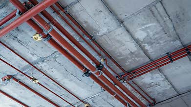 Fire suppression system pipes and sprinkler heads under concrete ceiling
