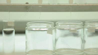 Tracking shot of glass beakers in a lab