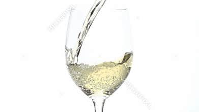 White wine pouring into glass in slow motion