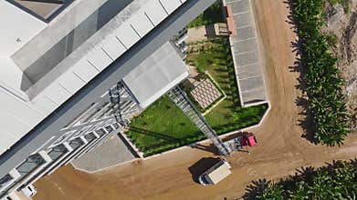 Aerial View: Workers transport heavy furniture to high floors through balconies using an advanced lift.