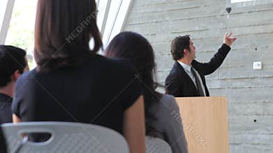 Businessman Giving Presentation At Conference