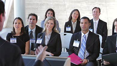 Businesspeople Listening To Speaker At Conference