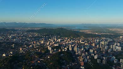Panoramic Drone View of a Mid-Sized Brazilian City with Buildings and Green Areas Under a Clear Sky
