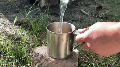 water from a stream in a bottle for boiling and disinfection