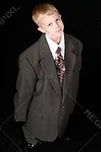 Boy in adult sized suit