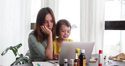 Mother and child engaging in telemedicine consultation from home