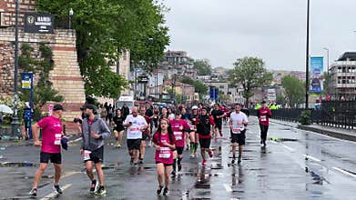 Athletes running Istanbul half marathon in historic street of Fener district