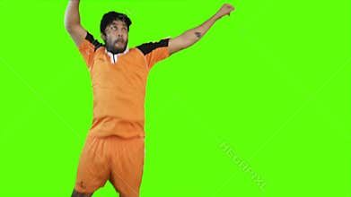 Soccer player heading a soccer ball on green background