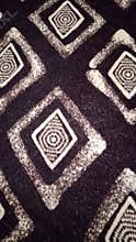Brown geometric diamond spiral fabric texture background