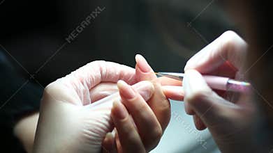 Nail master applying gel Polish, step by step guide. Manicurist is using a nail file,drill, first, remove cuticle with