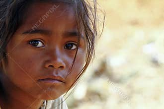 Poverty, portrait of a poor little African girl lost in deep tho