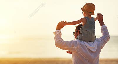 Father`s day. Dad and baby son playing together outdoors on a su