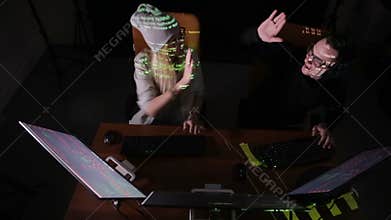 Two hackers at the computers.