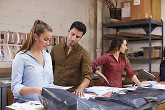 Male manager checking orders being packed for distribution