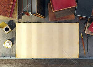 Old paper and ancient books on study table in medieval scene