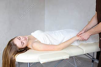 Experienced guy physician manually applies manual massage method