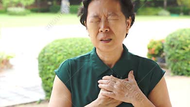 Senior Asian woman having heart attack, chest pain