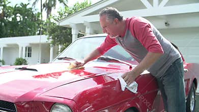 Retired Senior Man Cleaning Restored Classic Car