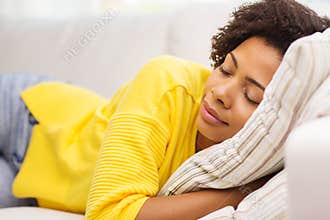 African young woman sleeping on sofa at home