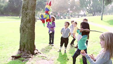 Children Hitting Pinata At Birthday Party In Slow Motion
