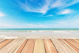 Wood floor on beach and blue sky background