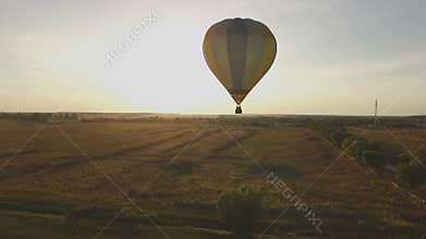 Flying a balloon at sunset