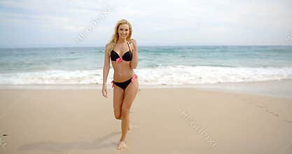 Blond Woman in Black Bikini Standing on Beach