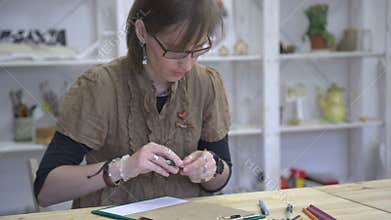 Female artist is drawing picture or sketch on brown paper.