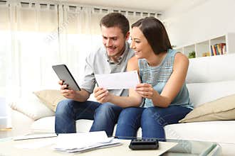 Happy couple checking bank account online