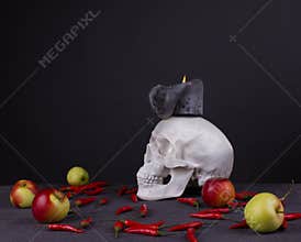 Halloween festival, skull with candle, apples and red pepper