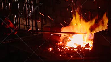 Slow Motion Blacksmith Forging a Sword