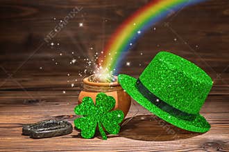 St Patricks day decoration with magic light rainbow pot full gold coins, horseshoe, green hat and shamrock on vintage wooden back