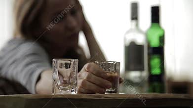 Sad lonely woman drinking alcohol from glasses in bar. female alcoholism, emotional instability and social tensions