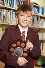 Portrait Of Pupil In Uniform Holding Award
