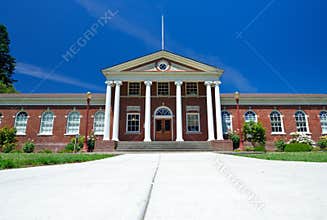 Classic Red Brick Building With Greek White Column Entrance