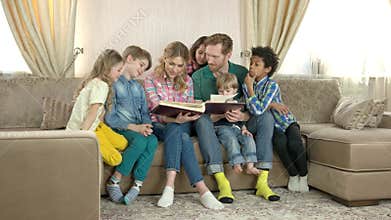 Family reading a book.