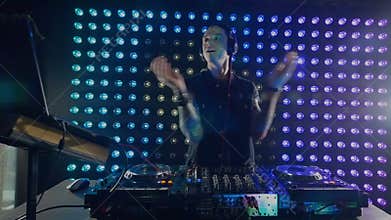 An energetic DJ working at the mixer.