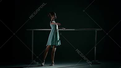 Young ballet dancer wearing an apricot tutu. slow