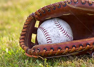 Worn Softball in Mitt
