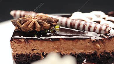 Close up of a cake containing top noire dough, chocolate and vanilla cream