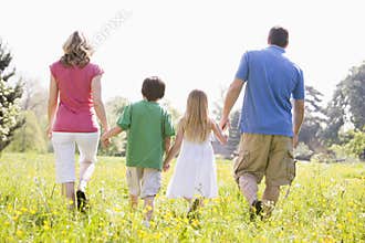 Family walking outdoors holding hands