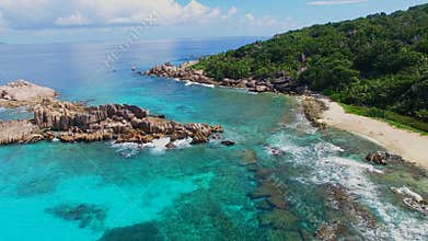 Aerial view of tropical paradise beach with white sand and crystal clear water of Indian Ocean La Digue Island, Seychelles