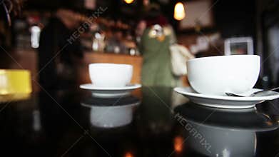 Coffee shop, Customers at the counter are visible in the background blur